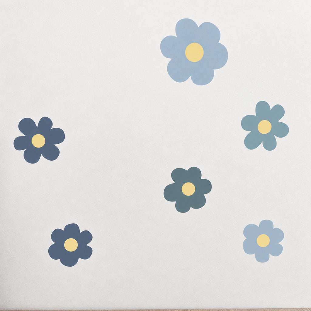 Blue flower wall decals scattered across a wall