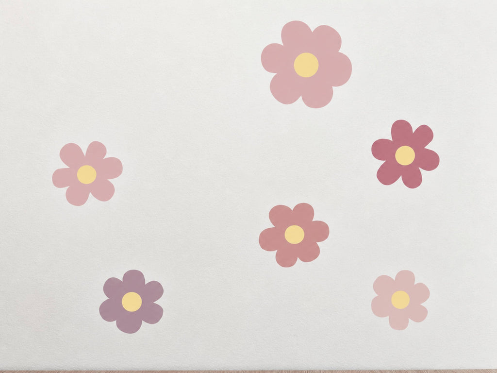 Pink flower wall decals scattered across a wall